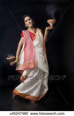 Bengali woman doing a dhunuchi dance View Large Photo Image Stock Image - Bengali woman doing a dhunuchi dance. Fotosearch