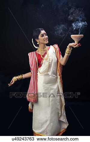 Bengali woman doing a dhunuchi dance View Large Photo Image Stock Image - Bengali woman doing a dhunuchi dance. Fotosearch