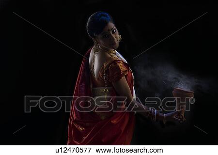 Stock Photo - Bengali woman doing a Dhunuchi dance . Fotosearch