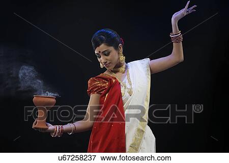 Bengali woman doing a Dhunuchi dance View Large Photo Image Stock Photo - Bengali woman doing a Dhunuchi dance . Fotosearch