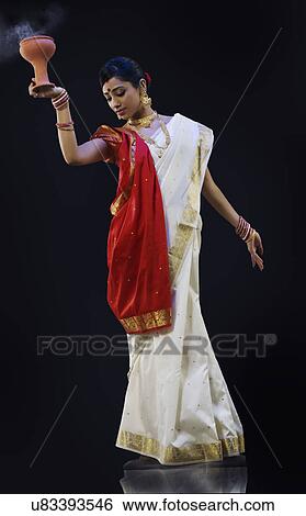 Bengali woman doing a Dhunuchi dance View Large Photo Image Stock Photograph - Bengali woman doing a Dhunuchi dance . Fotosearch
