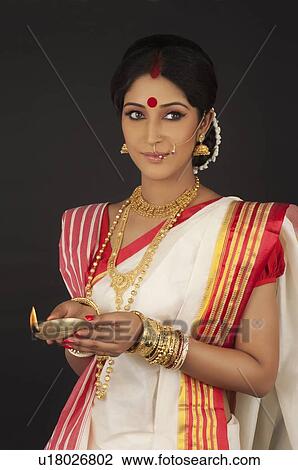Bengali woman holding a diya View Large Photo Image Stock Image - Bengali woman holding a diya. Fotosearch