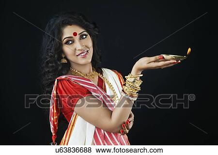 Stock Photo - Bengali woman holding a diya. Fotosearch