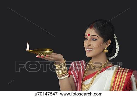 Bengali woman holding a diya View Large Photo Image Stock Photo - Bengali woman holding a diya . Fotosearch