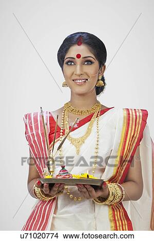 Bengali woman holding a puja thali View Large Photo Image Picture - Bengali woman holding a puja thali . Fotosearch