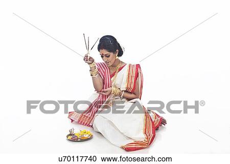 Bengali woman holding an agarbatti View Large Photo Image Stock Image - Bengali woman holding an agarbatti. Fotosearch