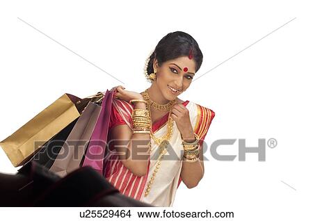 Bengali woman holding shopping bags View Large Photo Image Picture - Bengali woman holding shopping bags. Fotosearch