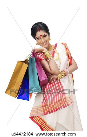 Bengali woman holding shopping bags View Large Photo Image Picture - Bengali woman holding shopping bags. Fotosearch