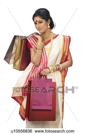 Bengali woman holding shopping bags View Large Photo Image Stock Photograph - Bengali woman holding shopping bags. Fotosearch