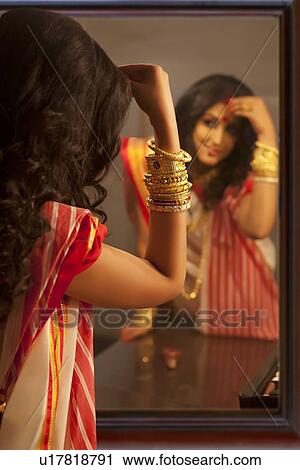 Bengali woman putting sindoor on her forehead View Large Photo Image Stock Image - Bengali woman putting sindoor on her forehead. Fotosearch