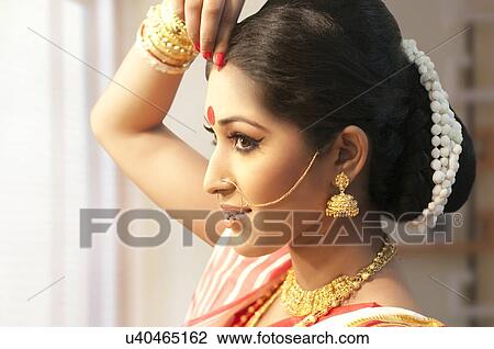 Bengali woman putting sindoor on her forehead View Large Photo Image Stock Image - Bengali woman putting sindoor on her forehead. Fotosearch