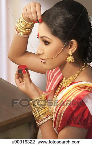 Bengali woman putting sindoor on her forehead View Large Photo Image Stock Image - Bengali woman putting sindoor on her forehead. Fotosearch