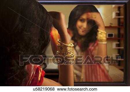 Bengali woman putting sindoor on her forehead View Large Photo Image Stock Photo - Bengali woman putting sindoor on her forehead. Fotosearch