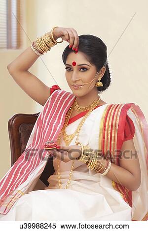 Bengali woman putting sindoor on her forehead View Large Photo Image Stock Photography - Bengali woman putting sindoor on her forehead. Fotosearch
