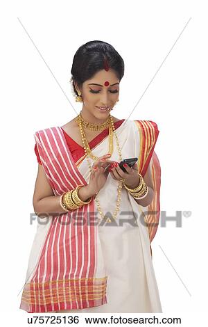 Stock Photograph - Bengali woman reading an sms on a mobile phone . Fotosearch