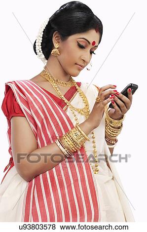 Bengali woman reading an sms View Large Photo Image Stock Photo - Bengali woman reading an sms. Fotosearch