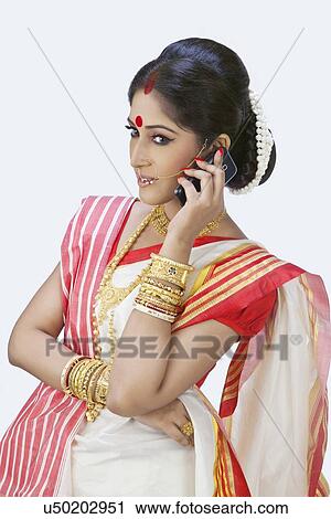 Bengali woman talking on a mobile phone View Large Photo Image Stock Image - Bengali woman talking on a mobile phone. Fotosearch