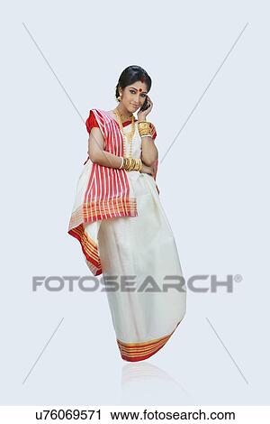 Stock Image - Bengali woman talking on a mobile phone. Fotosearch