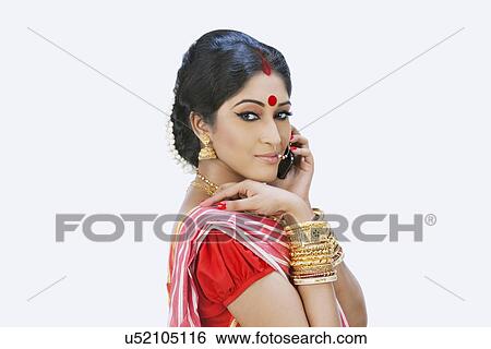 Stock Photograph - Bengali woman talking on a mobile phone. Fotosearch