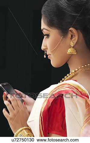 Bengali woman with a mobile phone View Large Photo Image Stock Image - Bengali woman with a mobile phone. Fotosearch