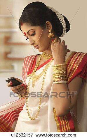 Stock Photo - Bengali woman with a mobile phone. Fotosearch