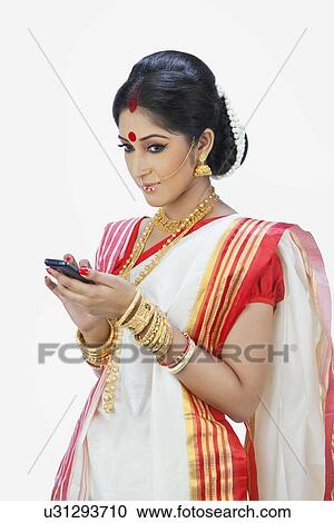 Stock Image - Bengali woman with mobile phone. Fotosearch