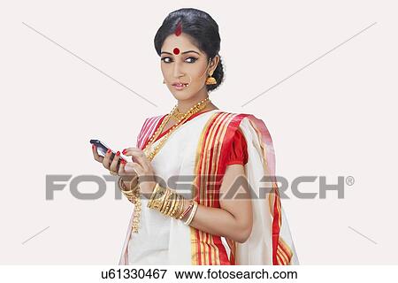 Bengali woman with mobile phone View Large Photo Image Stock Photo - Bengali woman with mobile phone. Fotosearch