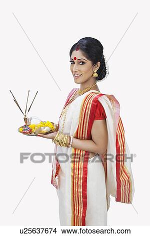Bengali woman with puja thali smiling View Large Photo Image Picture - Bengali woman with puja thali smiling. Fotosearch