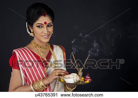Stock Image - Bengali woman with puja thali. Fotosearch