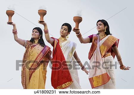 Bengali women doing a Dhunuchi dance View Large Photo Image Stock Image - Bengali women doing a Dhunuchi dance . Fotosearch