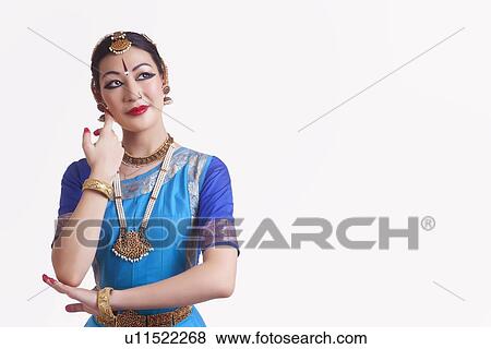Stock Photo - Bharata Natyam dancer performing over white background. Fotosearch