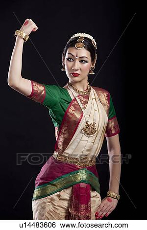 Bharatanatyam dancer flexing muscle over black background View Large Photo Image Stock Photograph - Bharatanatyam dancer flexing muscle over black background. Fotosearch