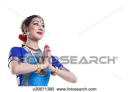 Bharatanatyam dancer in prayer position over white background View Large Photo Image Stock Image - Bharatanatyam dancer in prayer position over white background. Fotosearch
