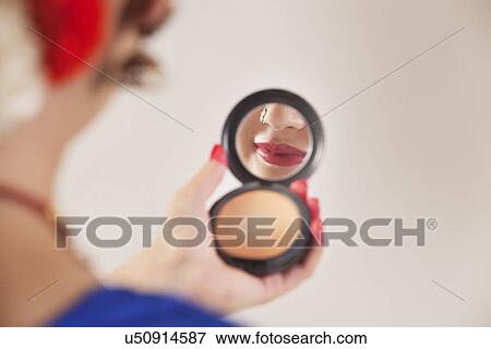 Bharatanatyam dancer looking in hand mirror over white background View Large Photo Image Stock Photo - Bharatanatyam dancer looking in hand mirror over white background. Fotosearch
