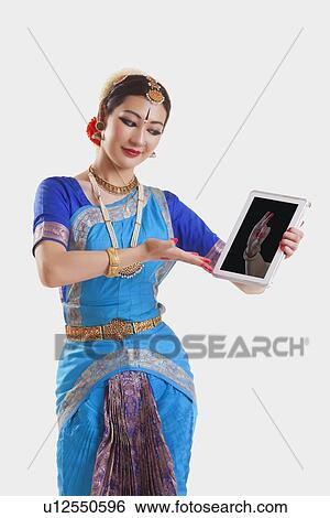 Bharatanatyam dancer showing Bhramara mudra on digital tablet over white background View Large Photo Image Stock Photograph - Bharatanatyam dancer showing Bhramara mudra on digital tablet over white background. Fotosearch