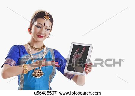 Stock Photo - Bharatanatyam dancer showing Simhamukha mudra on digital tablet over white background. Fotosearch