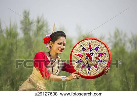 Stock Photo - Bihu dancer holding a jaapi . Fotosearch