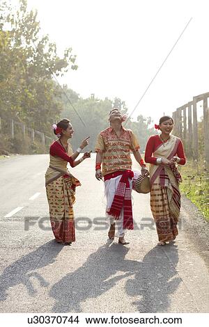 Bihu dancers sharing a laugh View Large Photo Image Picture - Bihu dancers sharing a laugh . Fotosearch