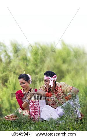 Stock Image - Bihu dancers sitting together . Fotosearch