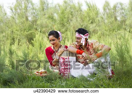 Stock Photo - Bihu dancers sitting together . Fotosearch