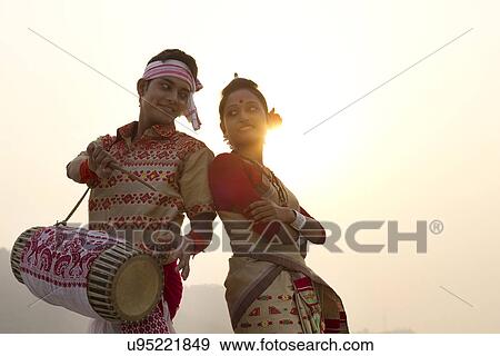 Stock Photo - Bihu dancers standing back to back . Fotosearch