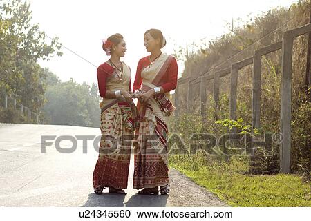 Stock Image - Bihu dancers talking . Fotosearch