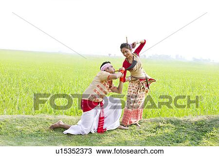Bihu man blowing on a pepa while Bihu woman dances to his tune View Large Photo Image Stock Image - Bihu man blowing on a pepa while Bihu woman dances to his tune . Fotosearch