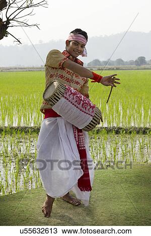 Stock Image - Bihu man playing on a dhol . Fotosearch