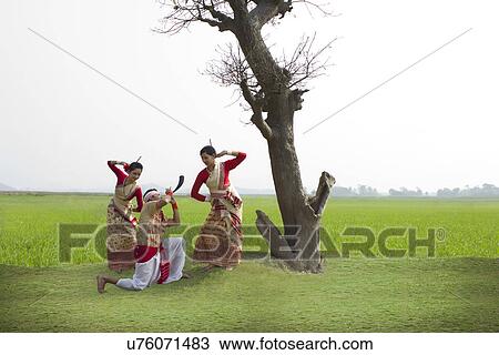 Bihu man playing on a pepa while Bihu women dance to his tune View Large Photo Image Stock Image - Bihu man playing on a pepa while Bihu women dance to his tune . Fotosearch