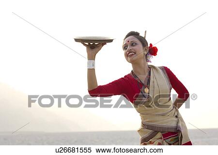 Bihu woman dancing with a brass plate View Large Photo Image Stock Photography - Bihu woman dancing with a brass plate . Fotosearch
