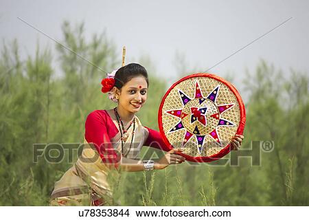 Bihu woman holding a jaapi View Large Photo Image Picture - Bihu woman holding a jaapi . Fotosearch
