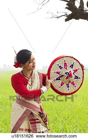 Bihu woman holding a jaapi View Large Photo Image Stock Photograph - Bihu woman holding a jaapi . Fotosearch