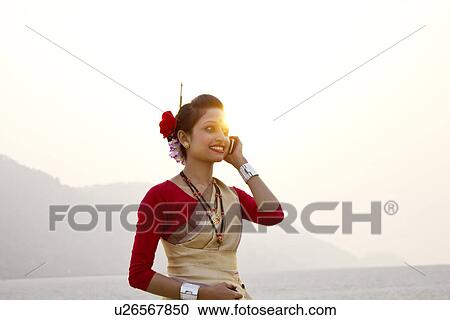 Bihu woman talking on a mobile phone View Large Photo Image Stock Image - Bihu woman talking on a mobile phone . Fotosearch