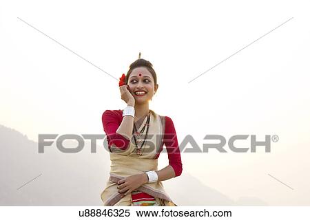 Stock Photography - Bihu woman talking on a mobile phone . Fotosearch